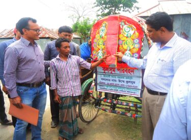 Honorable DC Mr. Kazi Abu Taher hands over a rickshaw to an enterprising member under the ENRICH Program for beggar rehabilitation.
